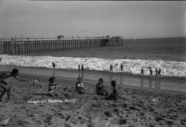 Models sitting on the beach.