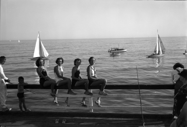 Models sitting on the rail of the Balboa Pier.